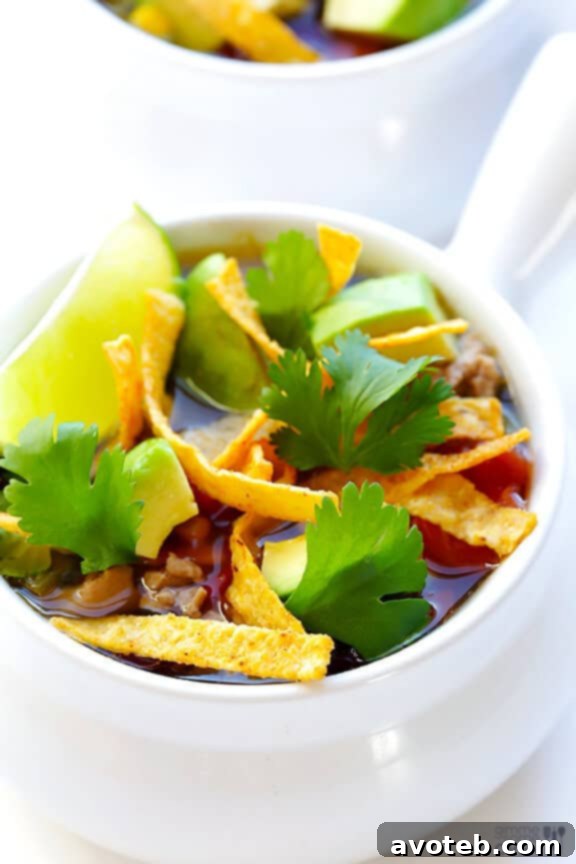 Close-up of Skinny Slow Cooker Taco Soup, showcasing its rich texture and vibrant ingredients.