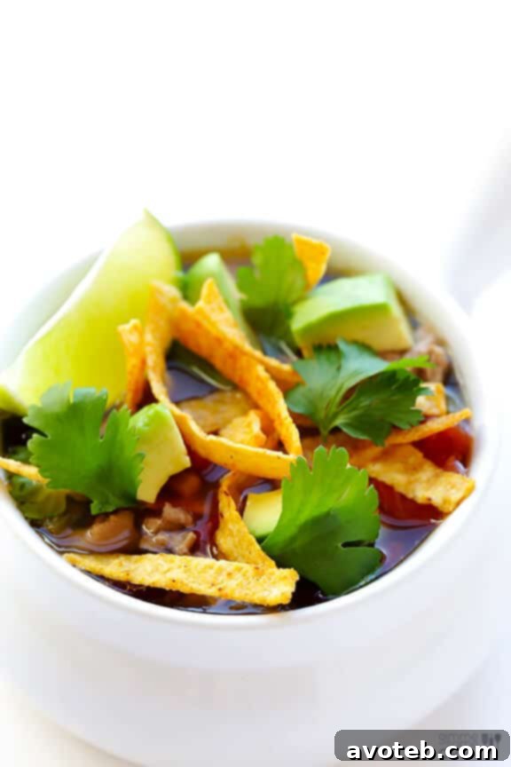 A large pot of Skinny Slow Cooker Taco Soup simmering to perfection, showcasing its vibrant ingredients.
