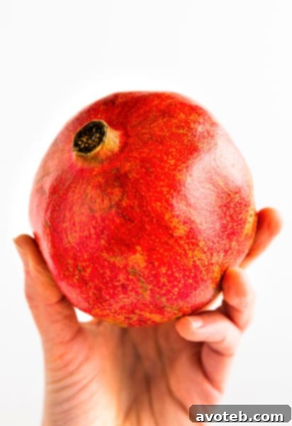 Pomegranate cut in half, showcasing its juicy arils, ready for de-seeding.