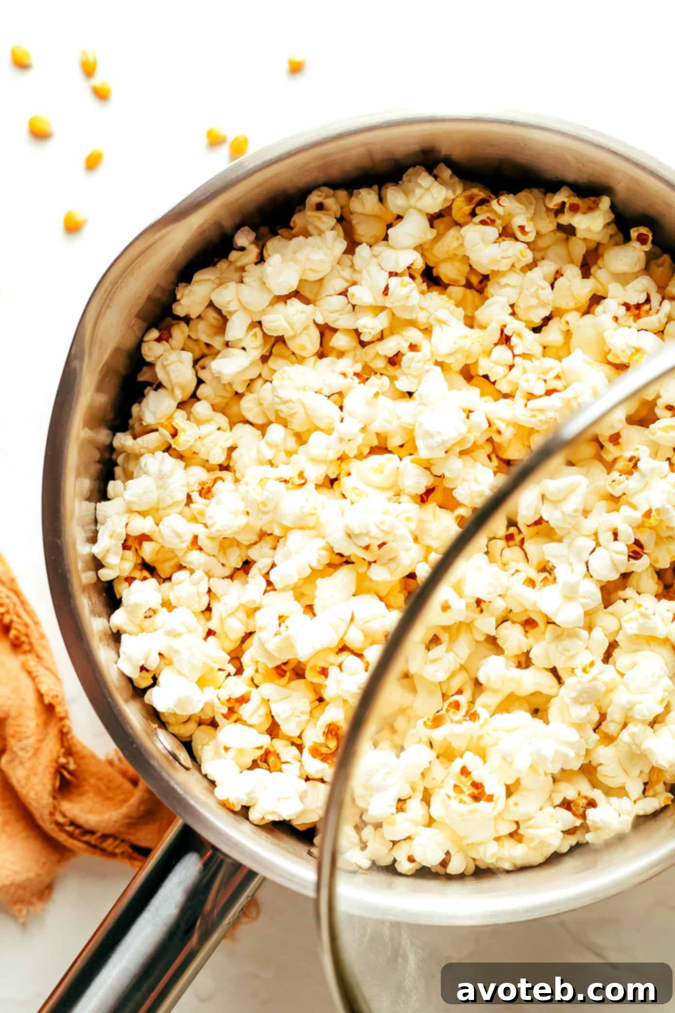 Freshly seasoned Nooch Popcorn in a large container