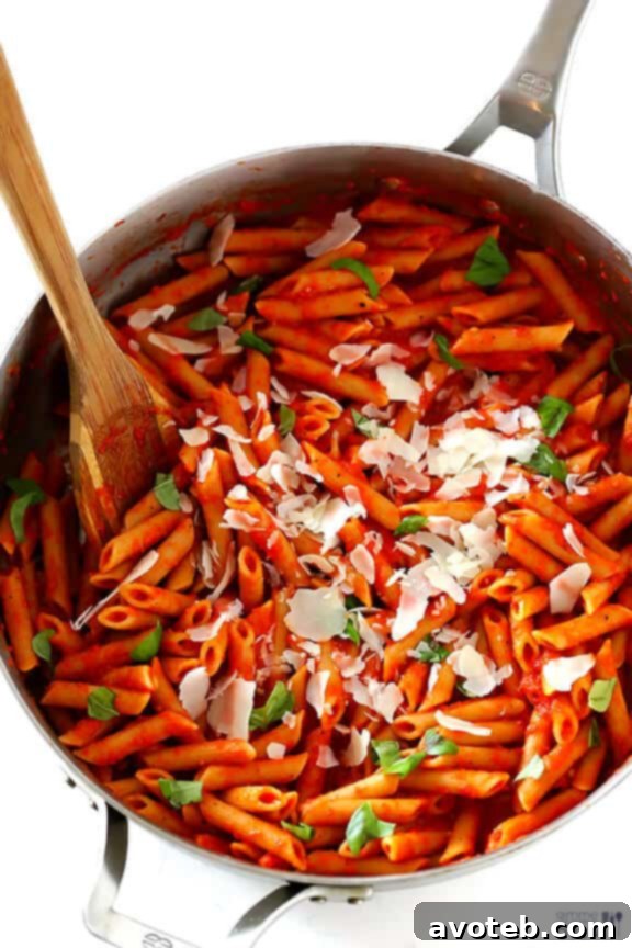 Vibrant red roasted red pepper pasta sauce in a skillet.