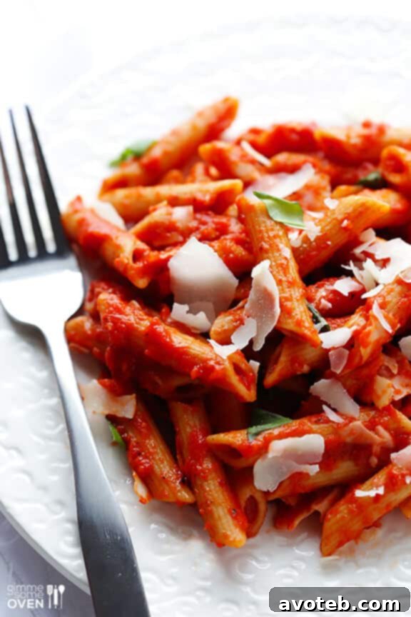 Close-up of a forkful of roasted red pepper pasta.