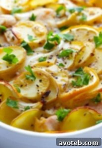 Easy Lemon Chicken Potato Casserole with lemon slices and herbs