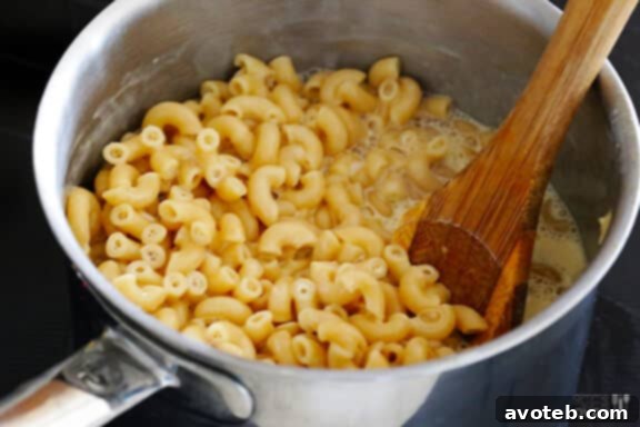 Macaroni and cheese sauce simmering to thicken.