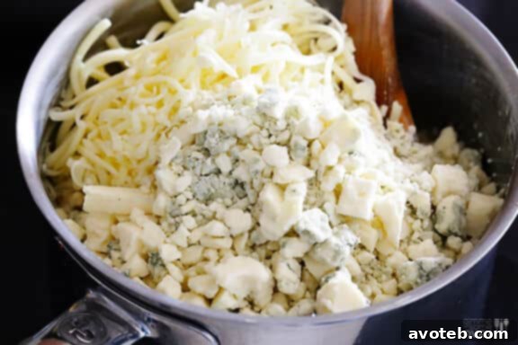 Adding crumbled blue cheese to macaroni and cheese.