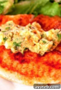 A perfectly cooked Tilapia with a generous dollop of melted Cilantro-Lemon Butter and a fresh lemon wedge.