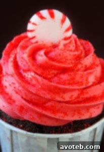 Stacked Peppermint Mocha Cupcakes with creamy white frosting and crushed candy canes, showcasing their delightful appearance.