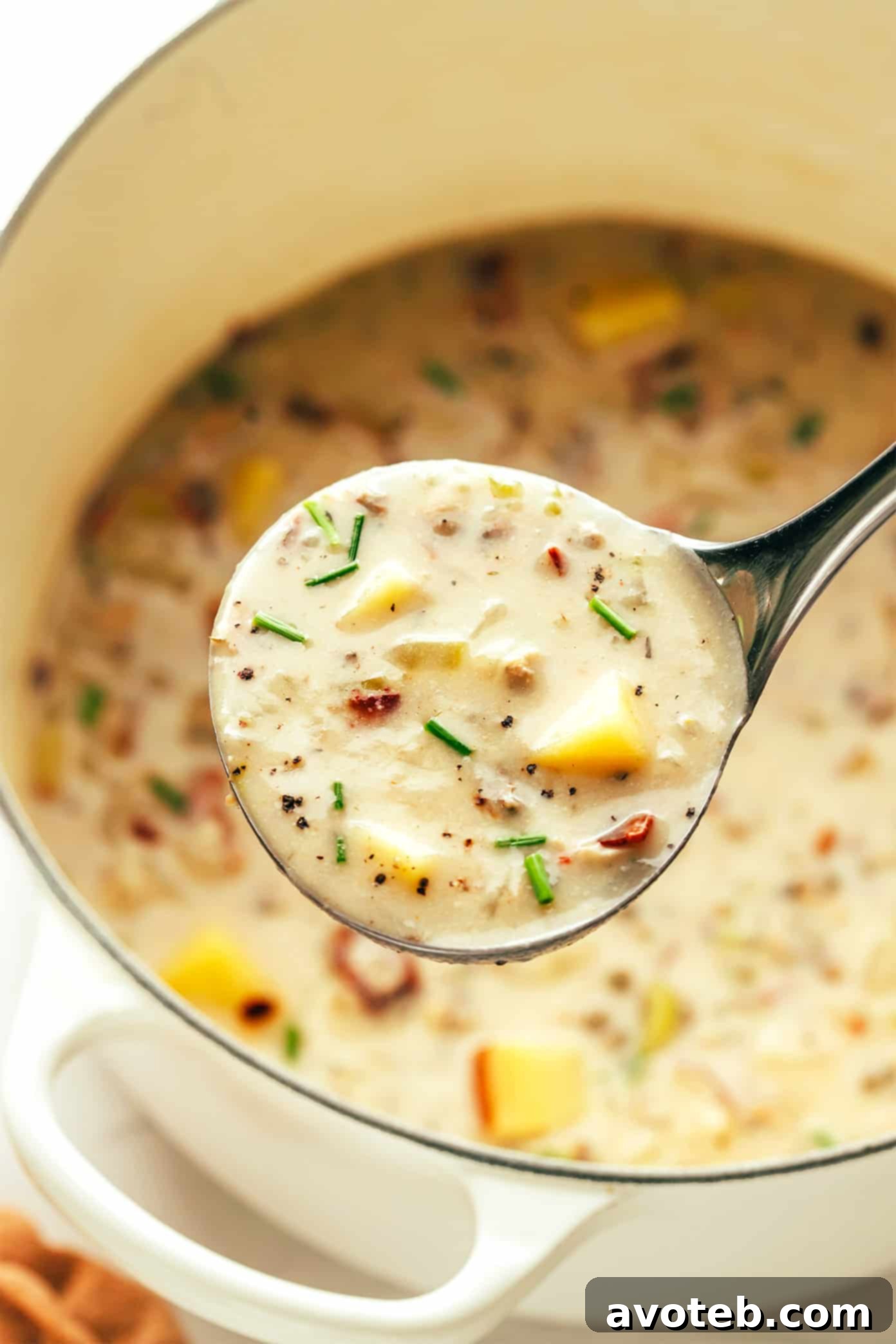 A bowl of finished clam chowder, perfectly garnished and ready to eat.