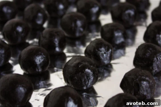 Close-up of freshly made Oreo Truffles, some with chocolate drizzle, ready to be served.