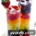 Rainbow Sangria in a glass with a vibrant mix of fruits.