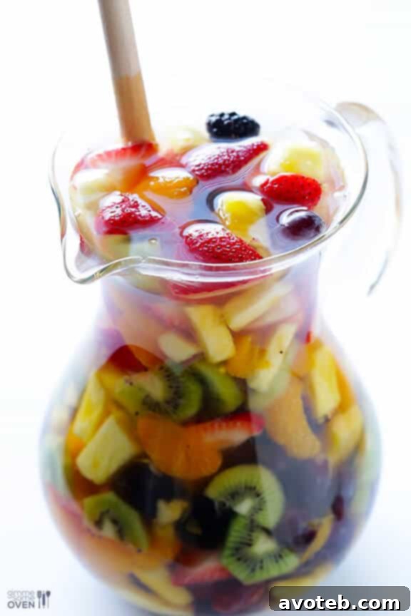Several glasses of Rainbow Sangria with abundant fruit, ready to be served.