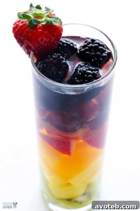 Two glasses of sangria with different fruit color themes: one warm-toned and one cool-toned.