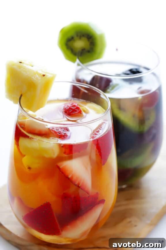 Glasses of Rainbow Sangria showcasing varied fruit arrangements.