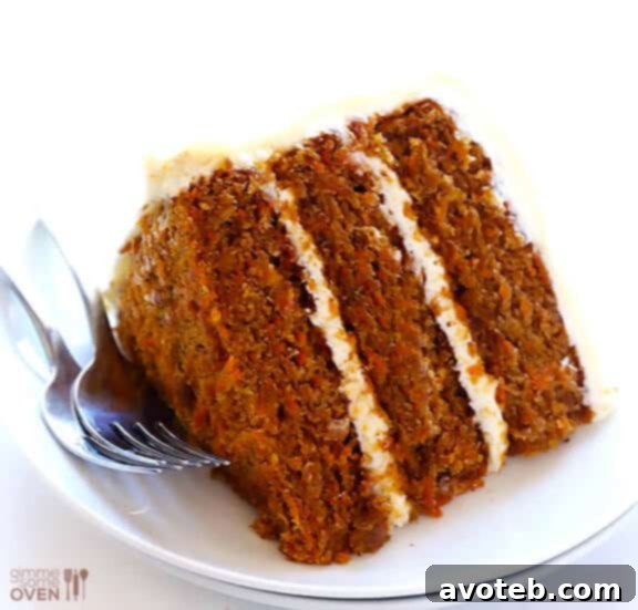 Close-up of a slice of moist Vegan Gluten-Free Carrot Cake with generous dairy-free frosting.