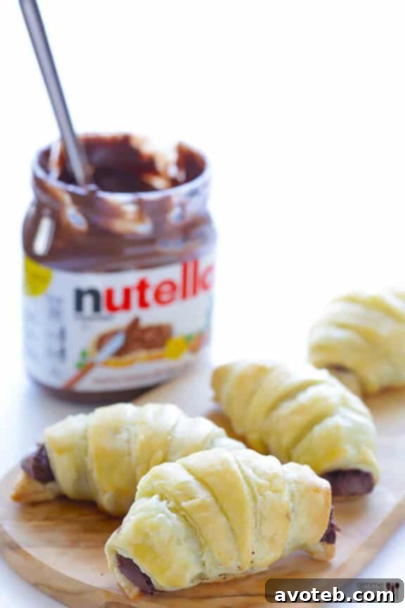 A basket full of golden, freshly baked 3-Ingredient Nutella Croissants
