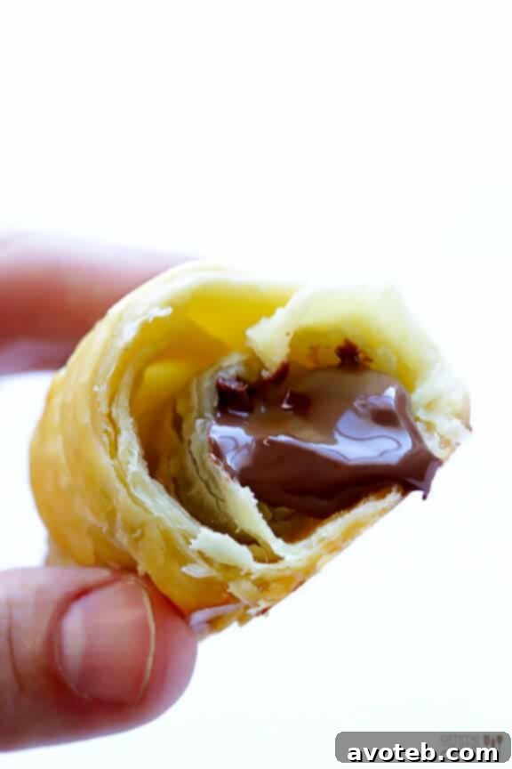 Close-up of a warm Nutella Croissant, revealing its gooey chocolate hazelnut center