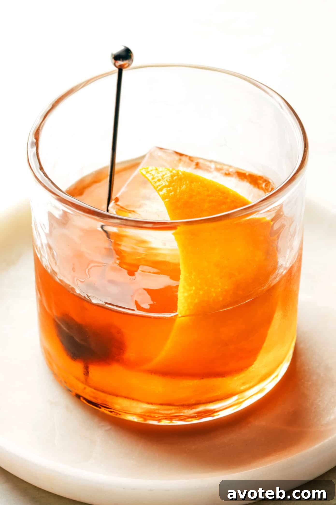 Enjoying a classic Old Fashioned cocktail: simple, satisfying, and sophisticated. A beautifully prepared Old Fashioned cocktail in a lowball glass, garnished with an orange peel.