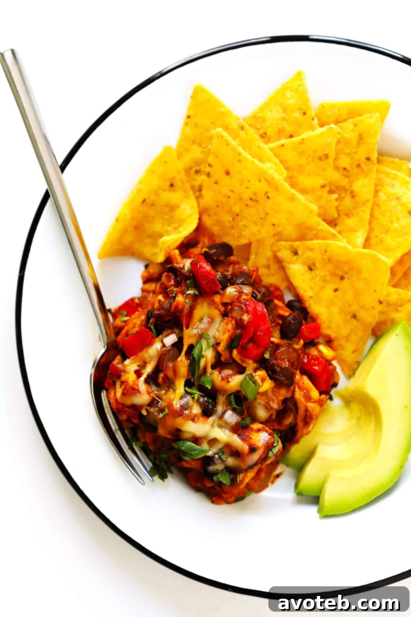 Chicken Enchilada Casserole with fresh avocado slices and cilantro