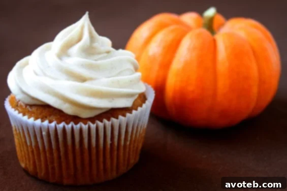 Decadent Pumpkin Cupcakes with Cinnamon Cream Cheese Frosting, perfect for autumn