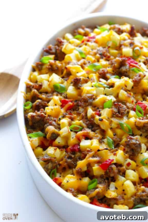 Serving spoonful of Easy Cheesy Breakfast Casserole on a plate with fresh toppings