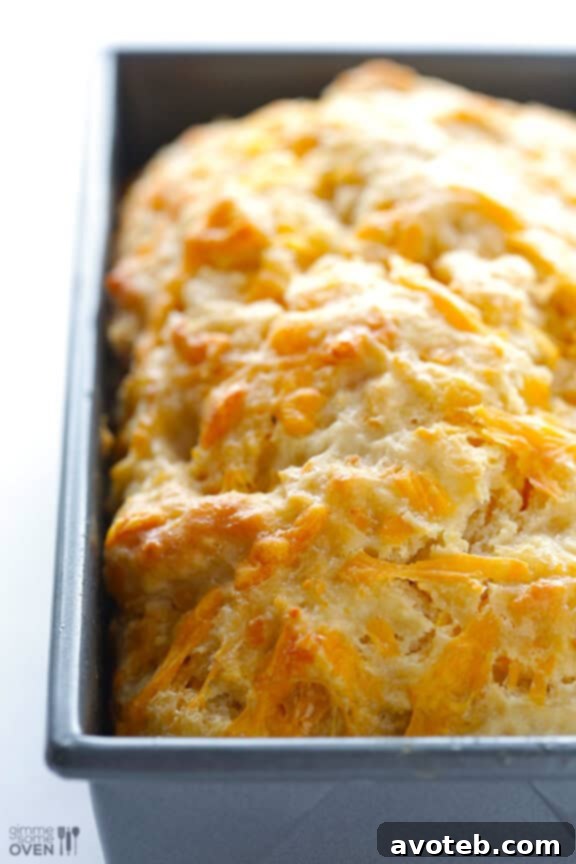 Close-up of freshly baked Garlic Cheddar Beer Bread, showcasing a golden crust.