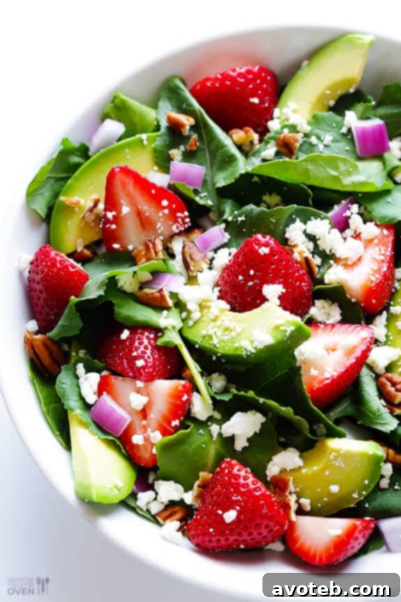Strawberry Kale Avocado Salad A spoonful of Strawberry Kale Salad with avocado, showcasing the harmonious blend of ingredients.