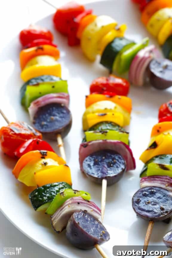 Grilled Rainbow Veggie Skewers served outdoors on a summer day.