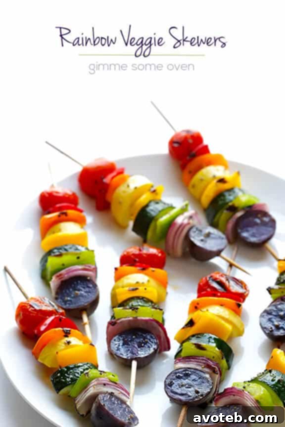 Close-up of freshly grilled rainbow veggie skewers on an outdoor table.