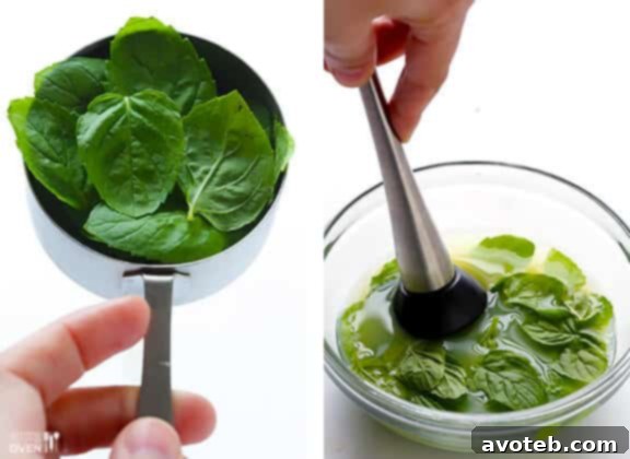 Muddling Mint for Mojito Pie Fresh mint leaves being muddled with lime juice in a glass, a key step for infusing mojito flavor into the pie filling.
