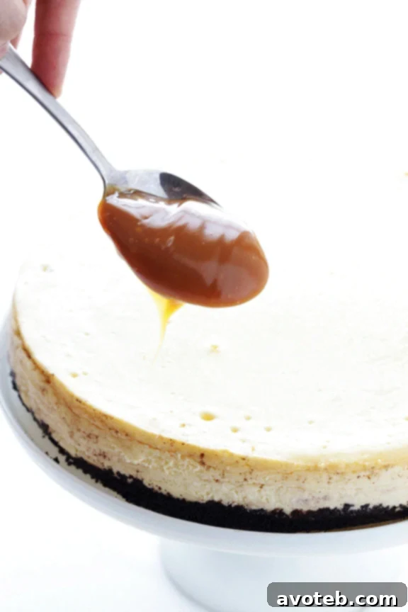 Preparing the Samoa Cheesecake topping: melted caramel, toasted coconut, and chocolate drizzle.