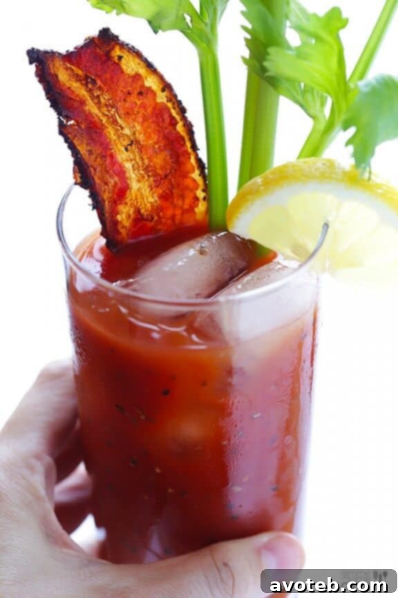 Crispy peppered bacon strips, the star garnish for a smoky Bloody Mary.