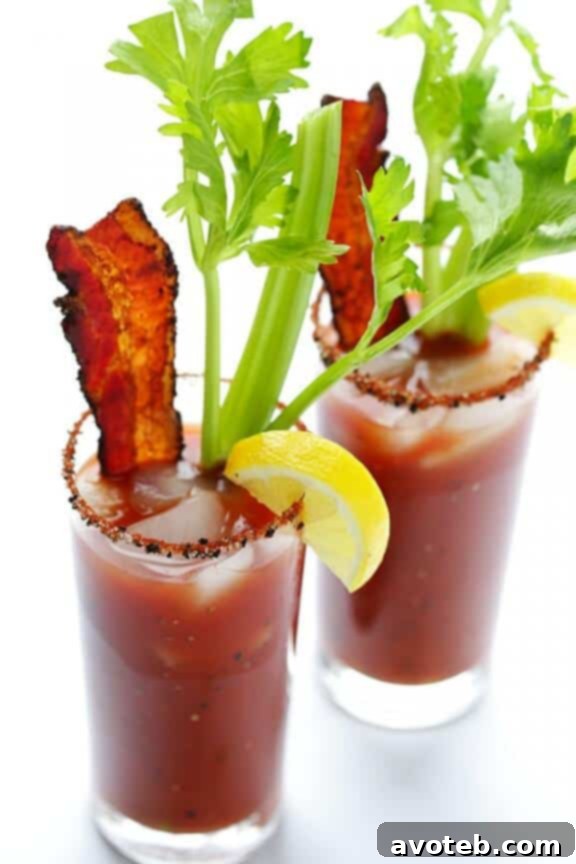 Refreshing Peppered Bacon Bloody Mary served in a tall glass with bacon garnish.