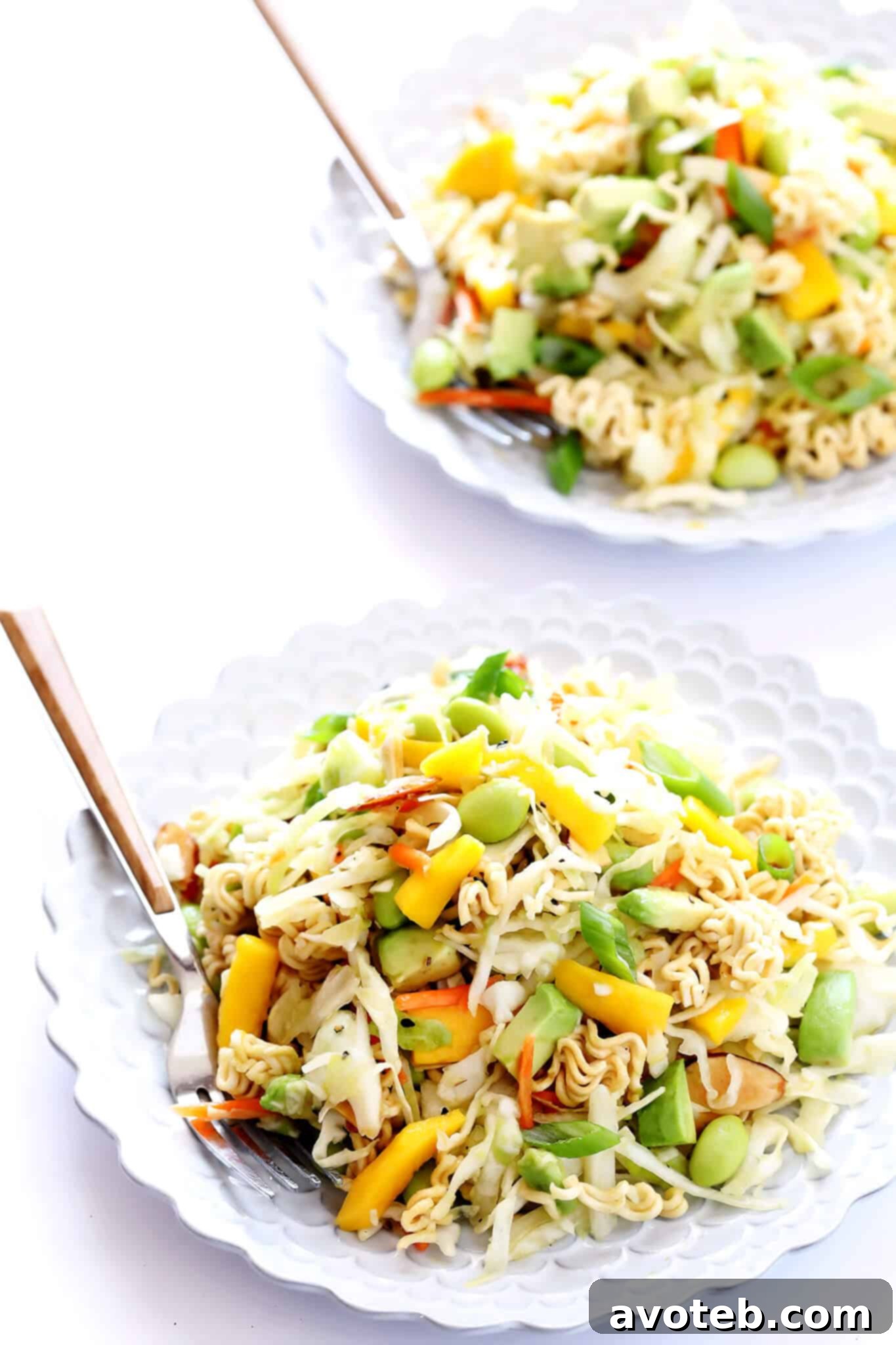 The finished Crunchy Ramen Noodle Salad presented in a serving bowl, garnished with black sesame seeds, ready to be enjoyed at a picnic or potluck.