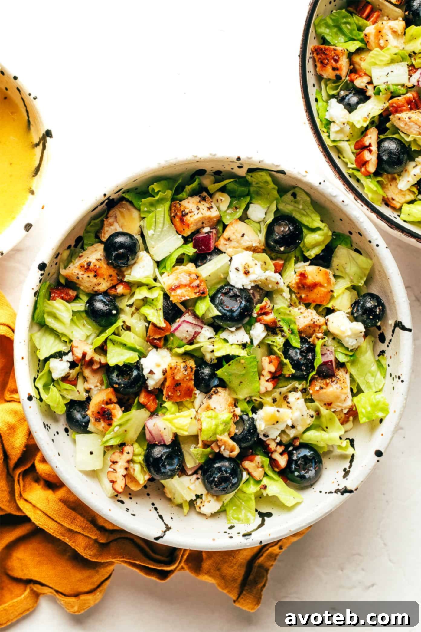 Two small, individual servings of Blueberry Chicken Chopped Salad, perfectly portioned and ready to enjoy, highlighting the vibrant ingredients.