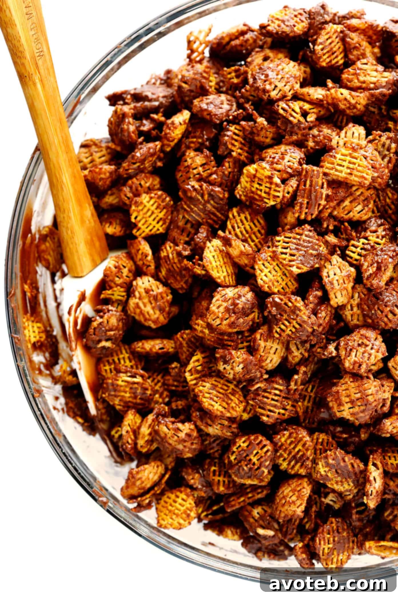 Chocolate Peanut Butter Dusted Bites 5 Chocolate mixture being poured over Chex cereal for Puppy Chow (Muddy Buddies).