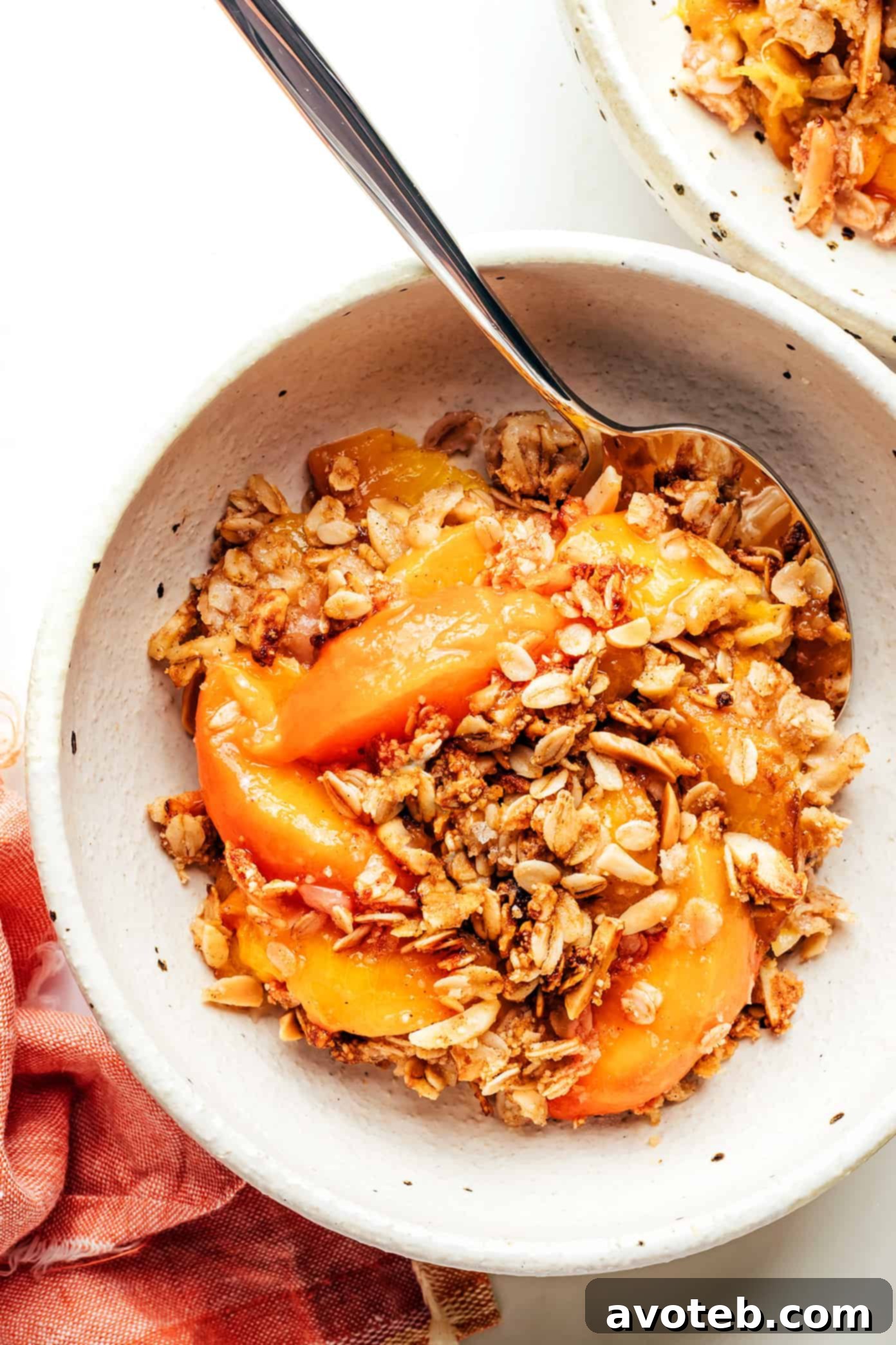 Delicious Ginger Peach Crisp with a scoop of vanilla ice cream, ready to be served.