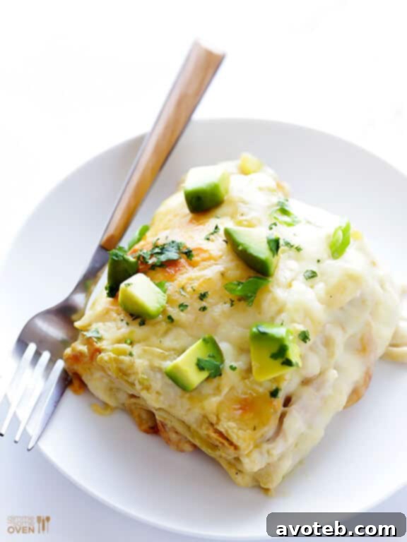 Delicious White Chicken Enchilada Casserole made with a creamy sauce and cheesy filling.