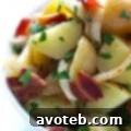 German Potato Salad garnished with fresh parsley.
