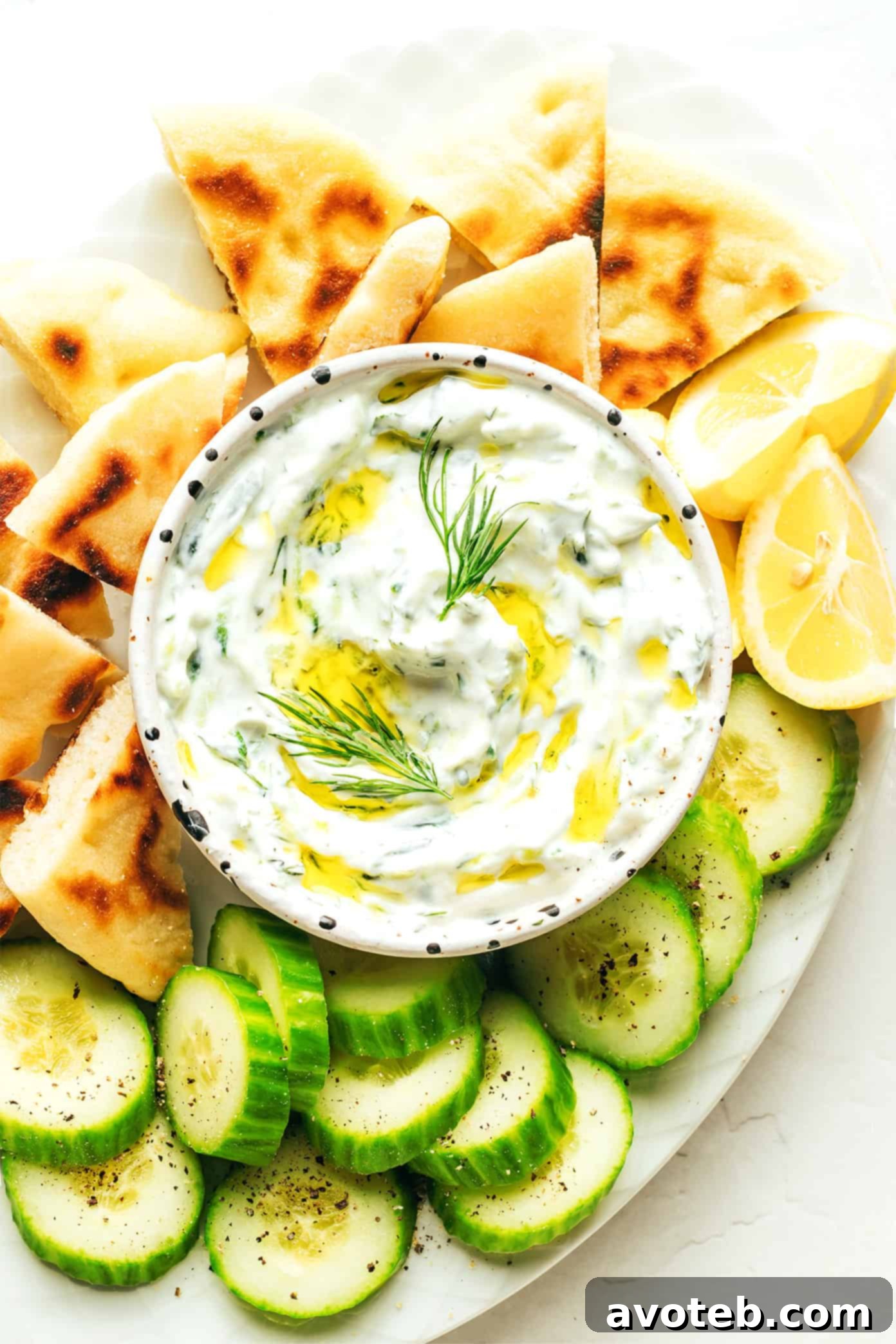 Freshly prepared Greek Tzatziki dip with a spoon, ready to serve.