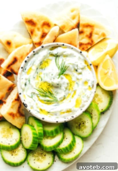 A vibrant bowl of fresh Tzatziki ready to be served, garnished with fresh dill.
