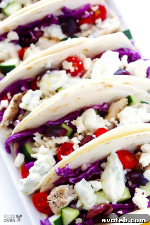 Plated Greek Fish Tacos ready to be eaten, garnished with lemon wedges