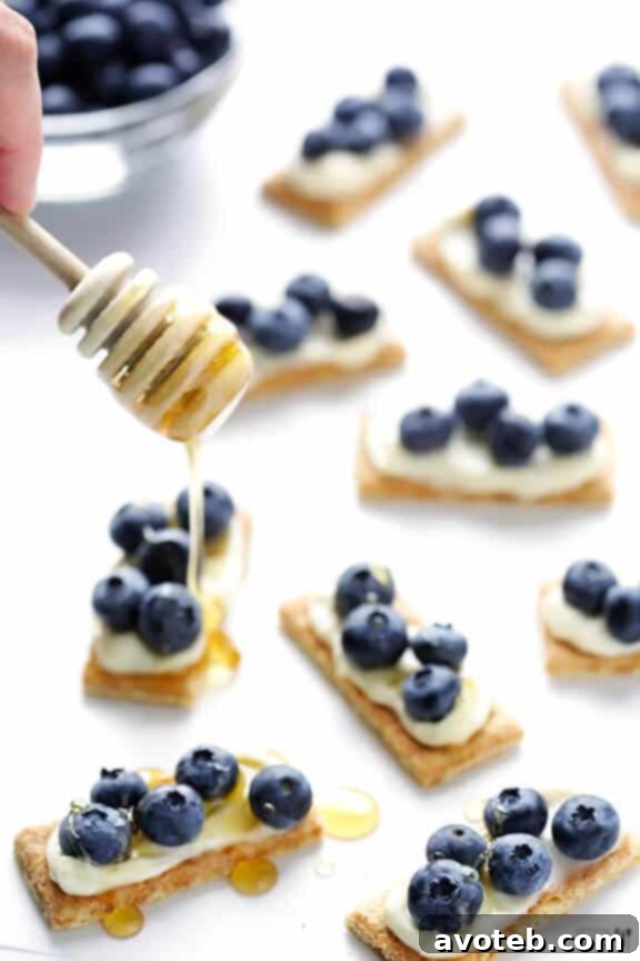 Step-by-step: Spreading The Laughing Cow cheese on a graham cracker for easy dessert bites