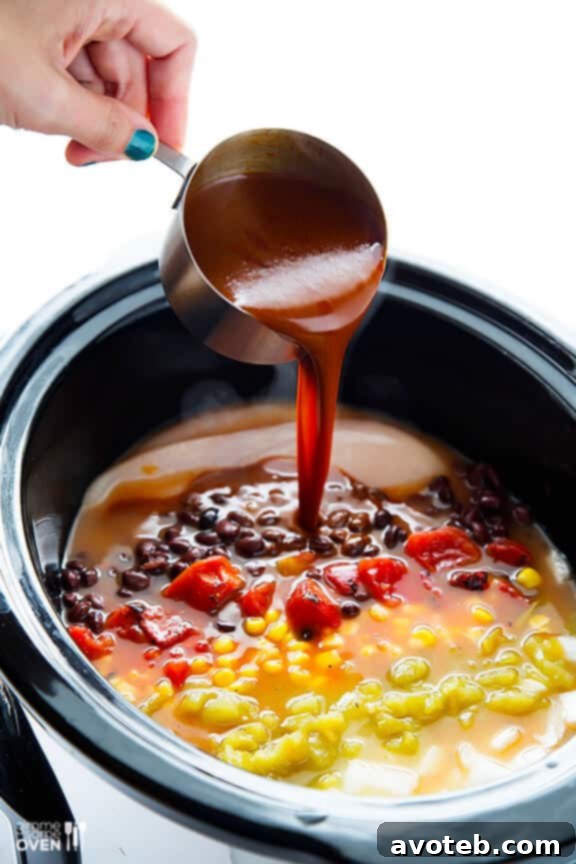 Layering Ingredients for Slow Cooker Chicken Enchilada Soup