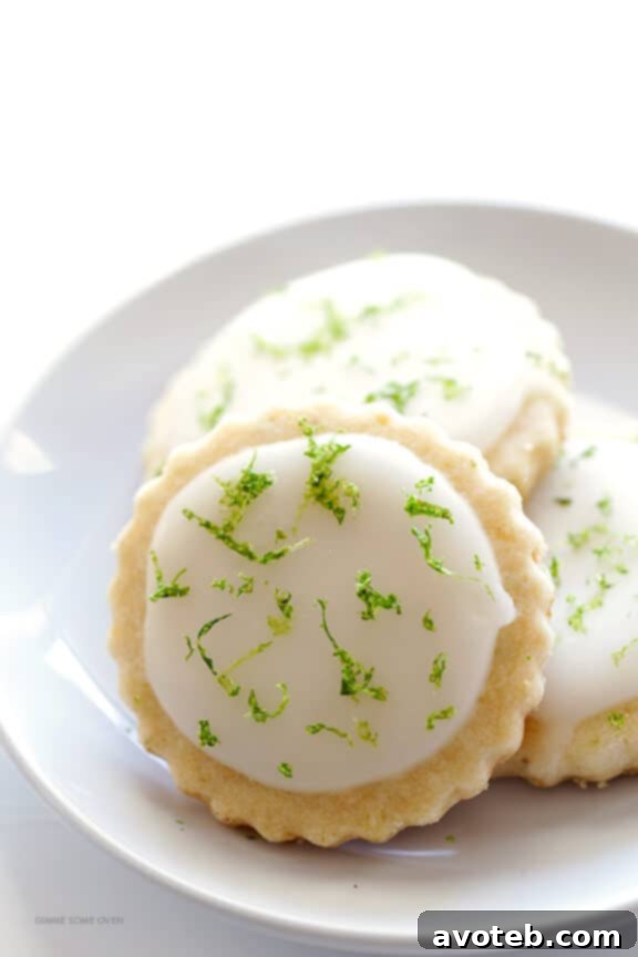 Tropical Coconut Lime Shortbread 6 A close-up of a Coconut Lime Shortbread Cookie being drizzled with a fresh lime glaze, showcasing the beautiful application.