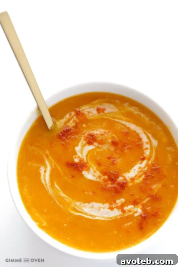 A smooth and creamy Slow Cooker Butternut Squash Soup, garnished with a swirl of cream.