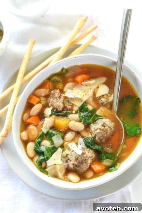 A hearty Slow Cooker Tuscan White Bean and Sausage Soup, brimming with rustic Italian flavors.