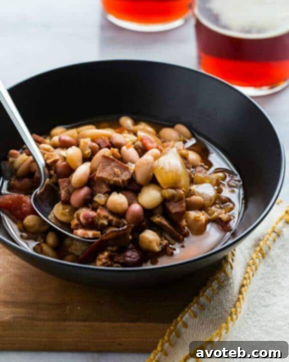 A hearty Slow Cooker Ham and Bean Soup, garnished with fresh parsley.