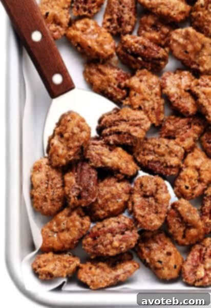 Perfectly baked candied pecans on a baking sheet, showcasing their golden crunch