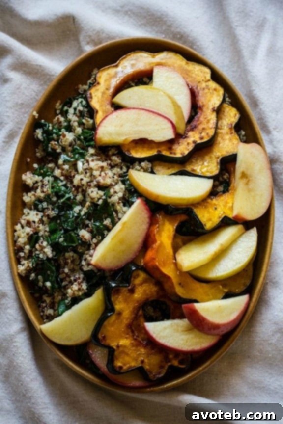 Hearty Roasted Acorn Squash, Apples, Quinoa, and Kale Salad with Maple Tahini Dressing