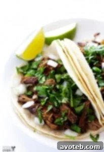 The finished slow cooker barbacoa beef, shredded and ready to serve, highlighting its rich color and inviting texture.